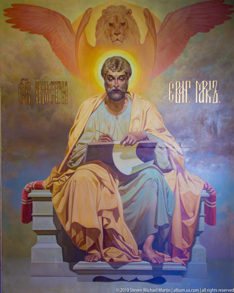 Mural of St. Mark seated with an open book and a winged lion above, inside St. Nicholas Church in Kotor.