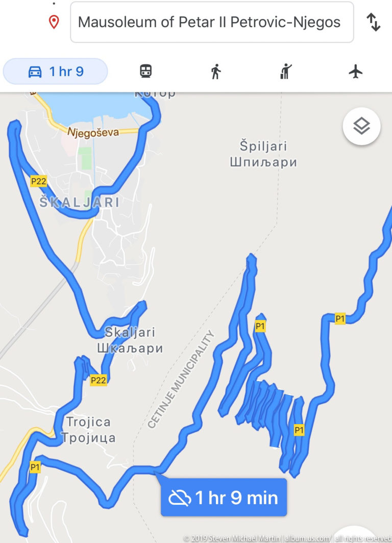 Digital map with a blue driving route winding through mountain switchbacks toward the Mausoleum of Petar II Petrović-Njegoš.