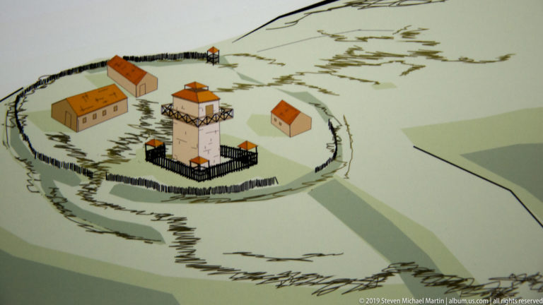 Interpretive reconstruction drawing of an early hilltop fortification with a central tower, enclosing defenses, and small buildings.