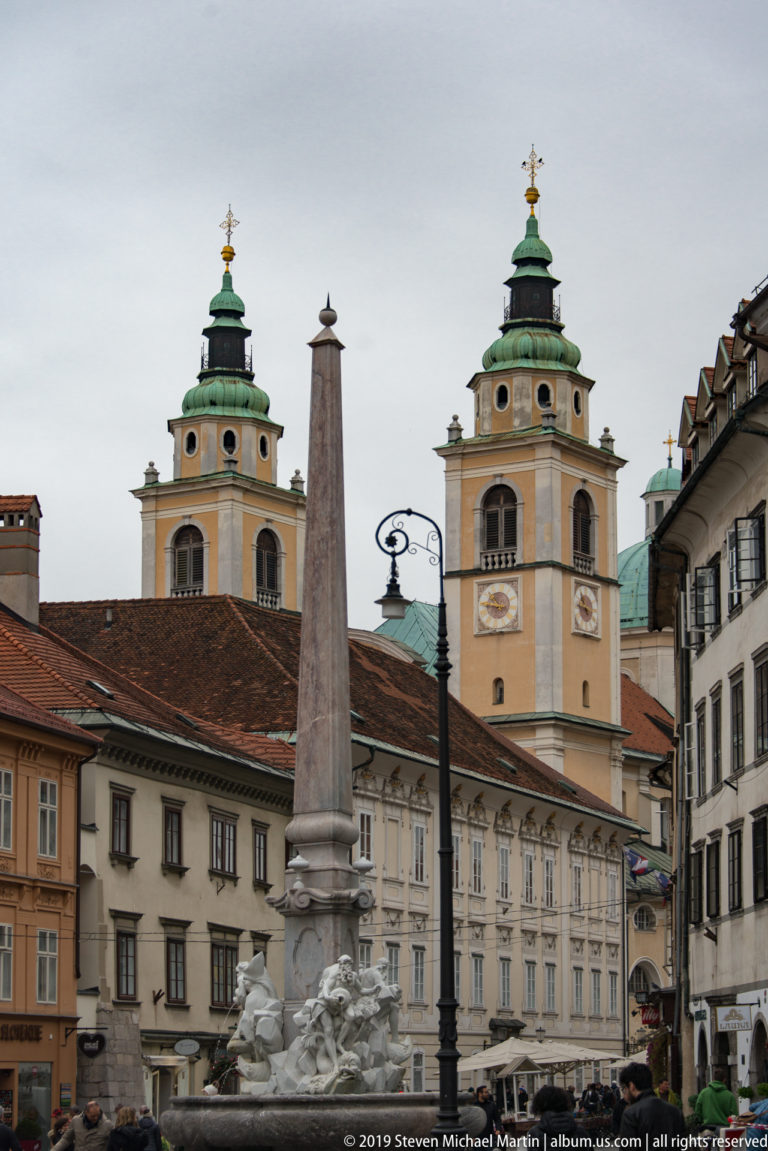 Robba Fountain obelisk in front of the twin bell towers of Ljubljana Cathedral in the old town.