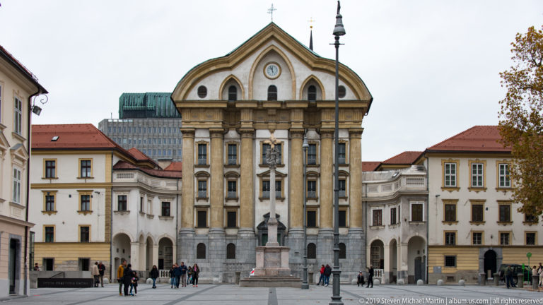 Baroque façade of the Ursuline Church of the Holy Trinity with the Holy Trinity Column in front on Congress Square.