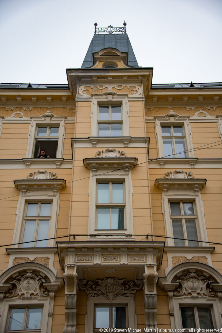 Ornate cream historic façade with projecting bays, carved window surrounds, and decorative upper stories.