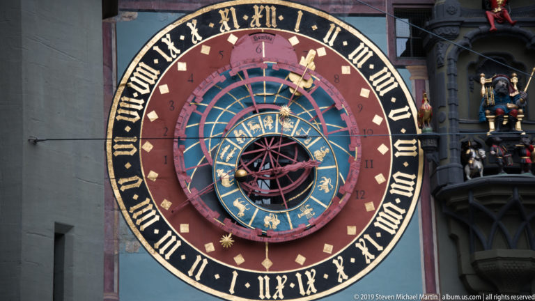 Full Zytglogge astronomical clock with zodiac symbols and adjacent mechanical figure bay.