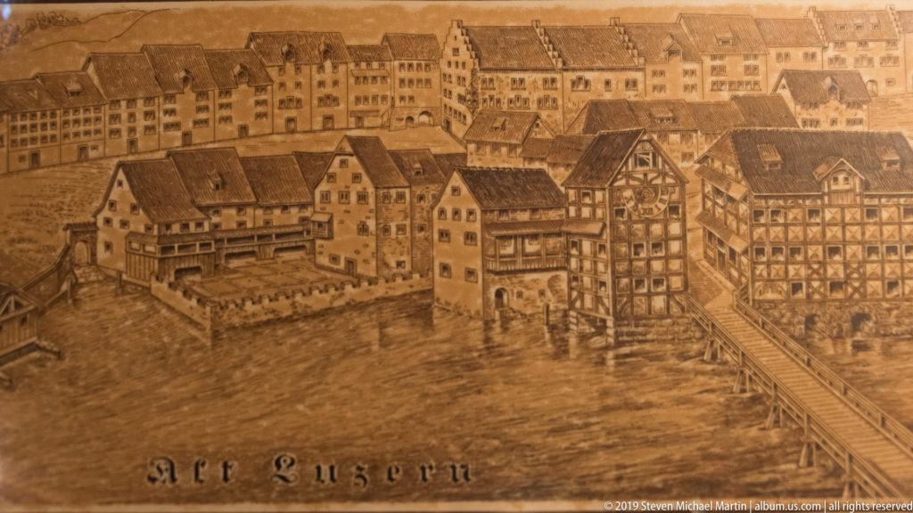Sepia historical illustration labeled Alt Luzern, showing old riverfront buildings and a bridge in Lucerne.
