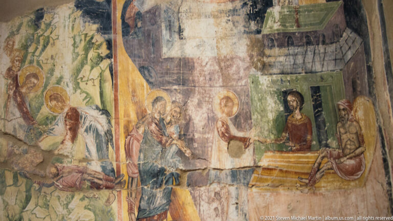 Weathered fresco cycle of haloed figures in several adjoining scenes divided by painted architectural settings.