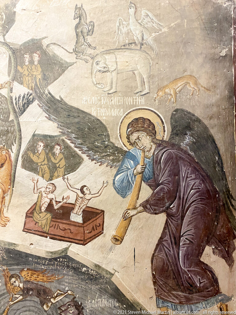 Winged angel above small resurrecting figures, coffins, fish, and Greek inscriptions in a Last Judgment fresco.