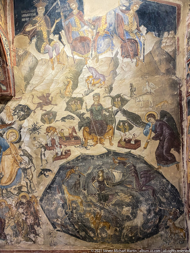 Large Last Judgment fresco with resurrecting figures, animals, tombs, and a dark circular sea zone below.
