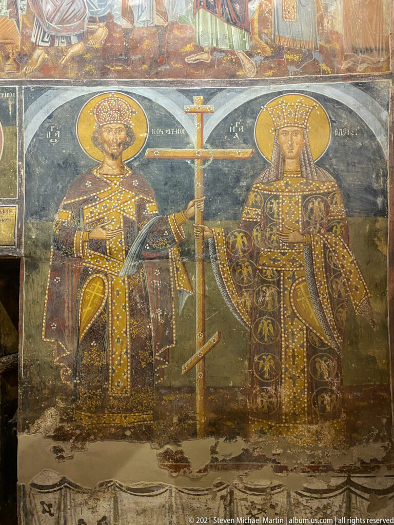 Saint Constantine and Saint Helena standing in imperial dress on either side of a tall cross.