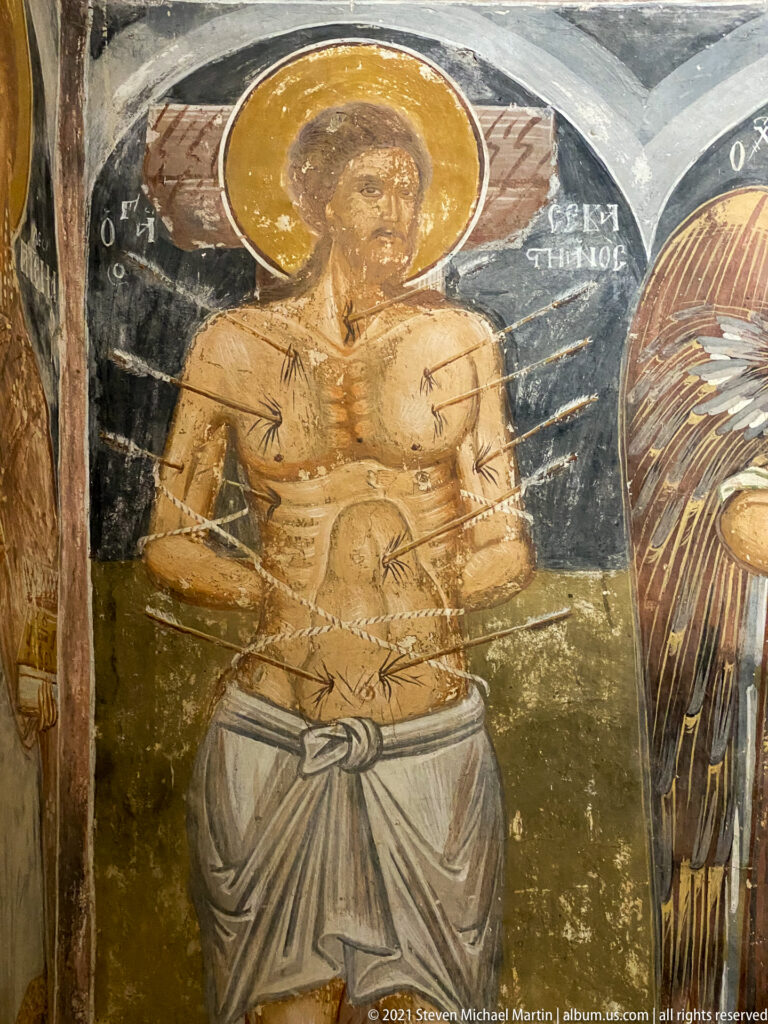 Haloed youthful martyr with bare torso, white waist cloth, and numerous arrows or wound marks across the body.
