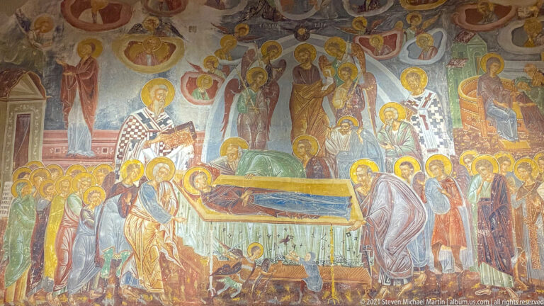 Dormition fresco with Virgin on a bier, apostles and bishops surrounding her, and Christ holding her soul above.