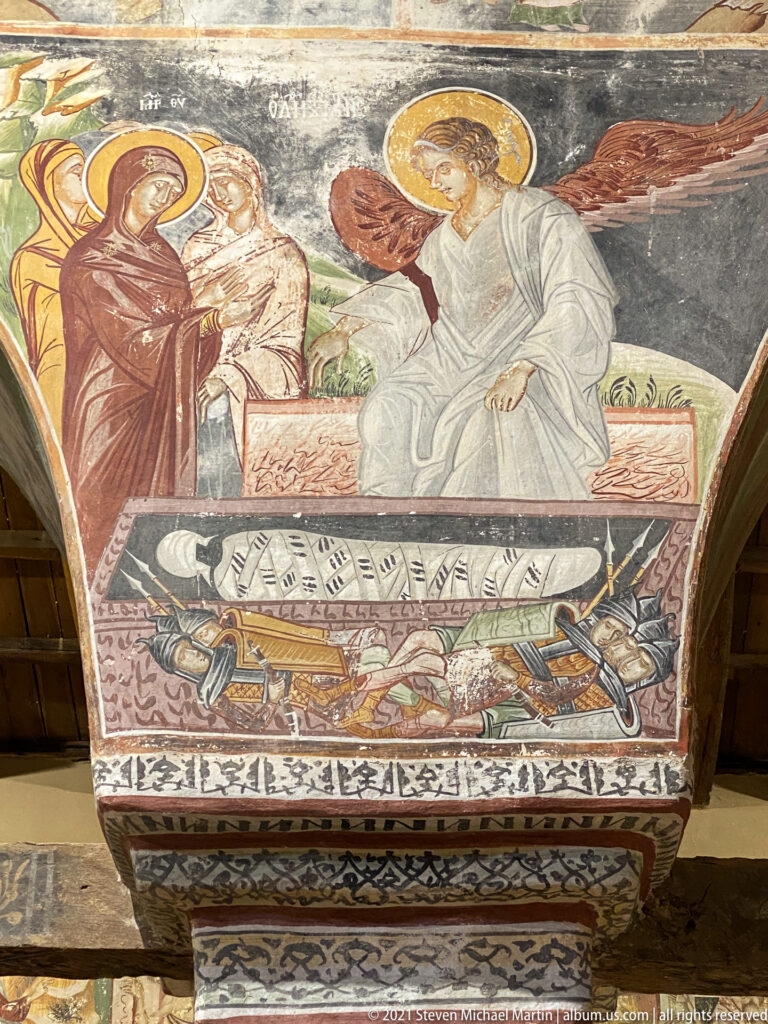 Nativity fresco with reclining Virgin and swaddled Christ Child above women bathing the infant.