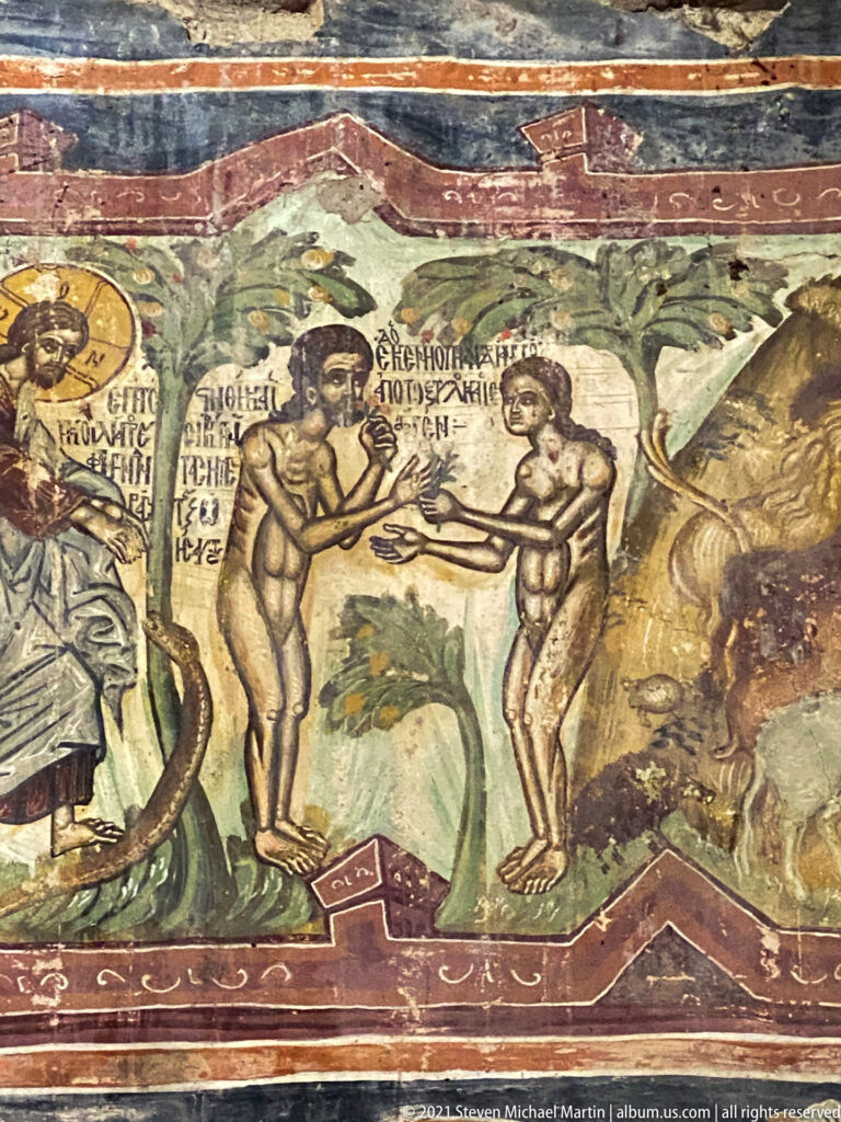 Adam and Eve stand nude beside a tree and serpent while a haloed divine figure addresses them from the left.