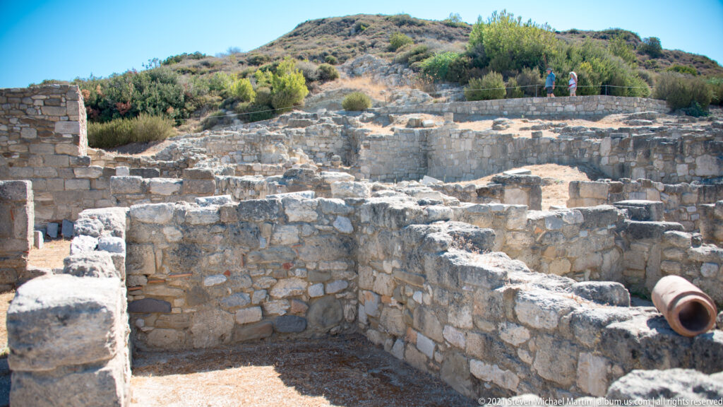 Excavated stone room walls and thresholds in the hillside residential quarter at Ancient Kamiros.