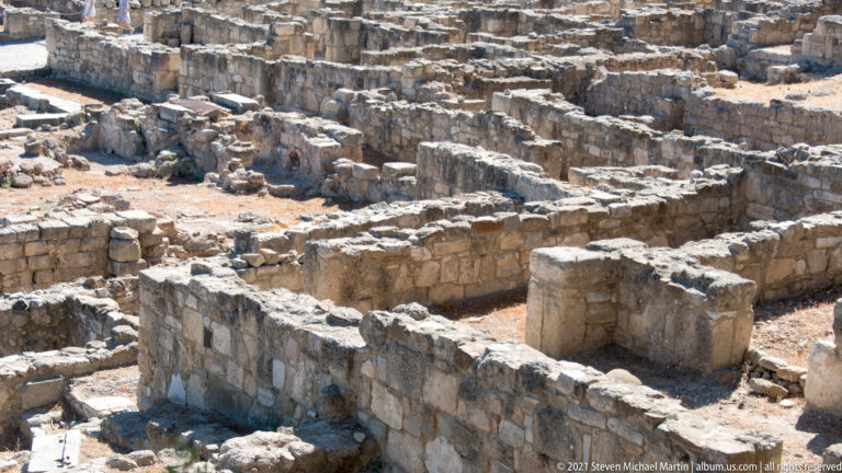 Close view of low stone walls forming tightly packed rectangular rooms and passages in the excavated city.