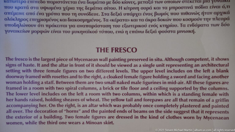 Bilingual museum panel titled “The Fresco,” with English text describing female figures, architecture, and surviving wall-painting fragments.