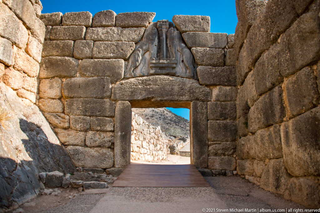 Interior view through the Lion Gate, with massive stone jambs, lintel, and lion relief above the opening.