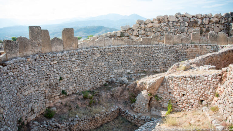 Elevated view of dense stone walls, rooms, and terraces inside the Mycenaean citadel.