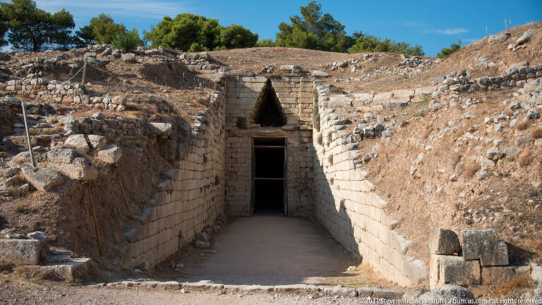 Long stone-lined dromos leading to the monumental entrance and relieving triangle of the Tomb of Clytemnestra at Mycenae.