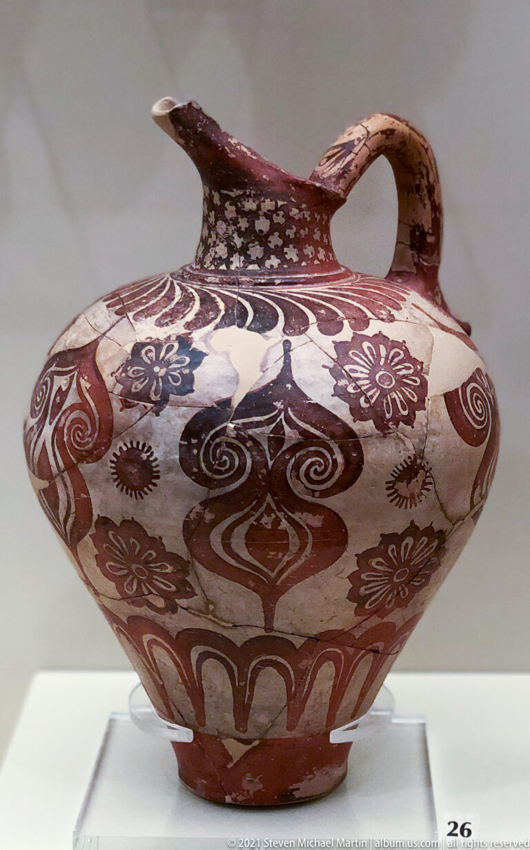 Large Mycenaean painted jar with high handle and dense red-brown spiral and floral decoration.