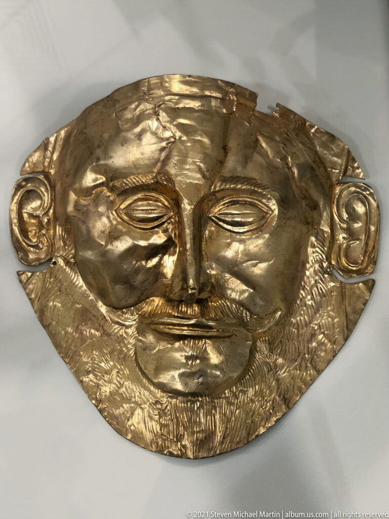 Bearded gold funerary mask conventionally called the Mask of Agamemnon, with closed eyes, moustache, and incised beard.