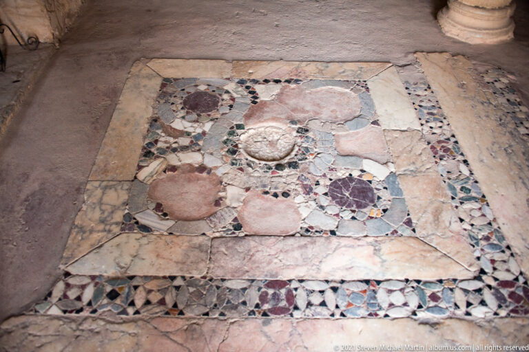 Rectangular decorative stone pavement panel with circular medallions and multicolored geometric borders inside St. Sophia.