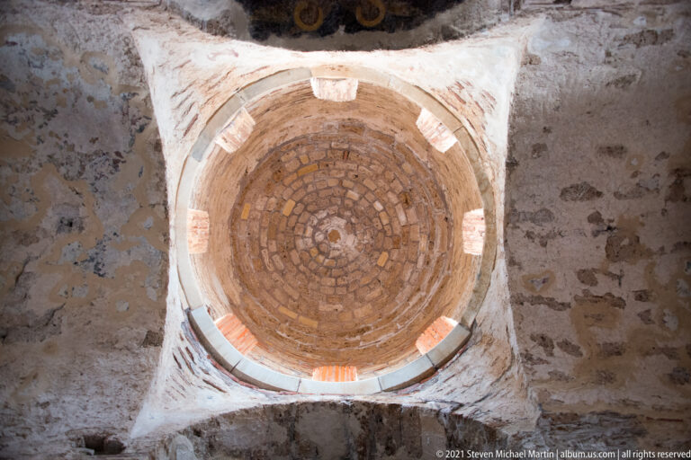 Upward view of a small concentric brick dome supported over a square bay inside St. Sophia.