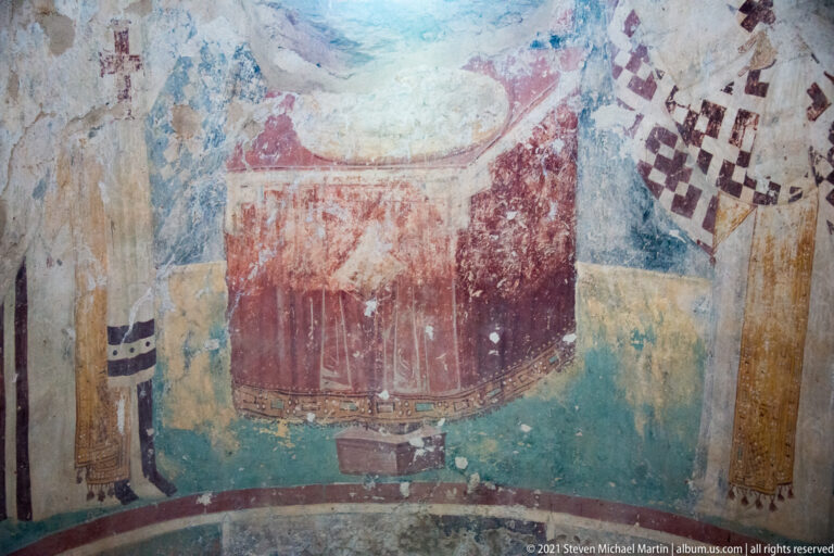 Fragmentary Byzantine fresco showing part of a richly robed figure beside a large red painted form in St. Sophia.