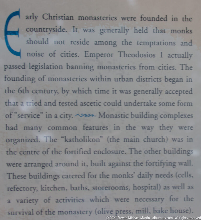 Close-up of English interpretive text at Mystras explaining urban monasteries and the organization of monastic building complexes.