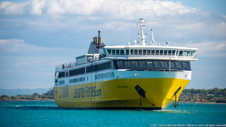Large yellow-and-white Levante Ferries passenger ship seen from the bow on turquoise water.