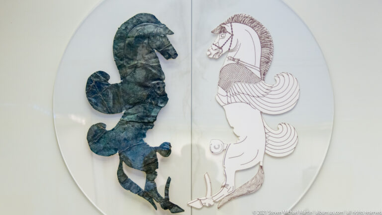 Fragmentary green bronze horse mounted beside a line drawing reconstructing the complete stylized animal.