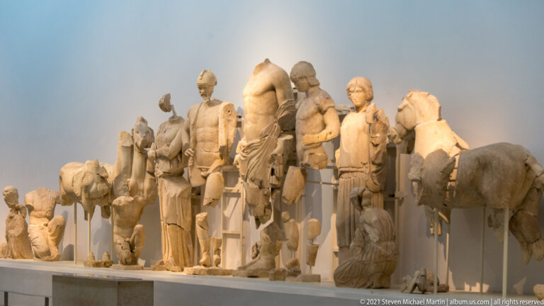Reconstructed east pediment of the Temple of Zeus with monumental marble figures from the story of Pelops and Oinomaos.
