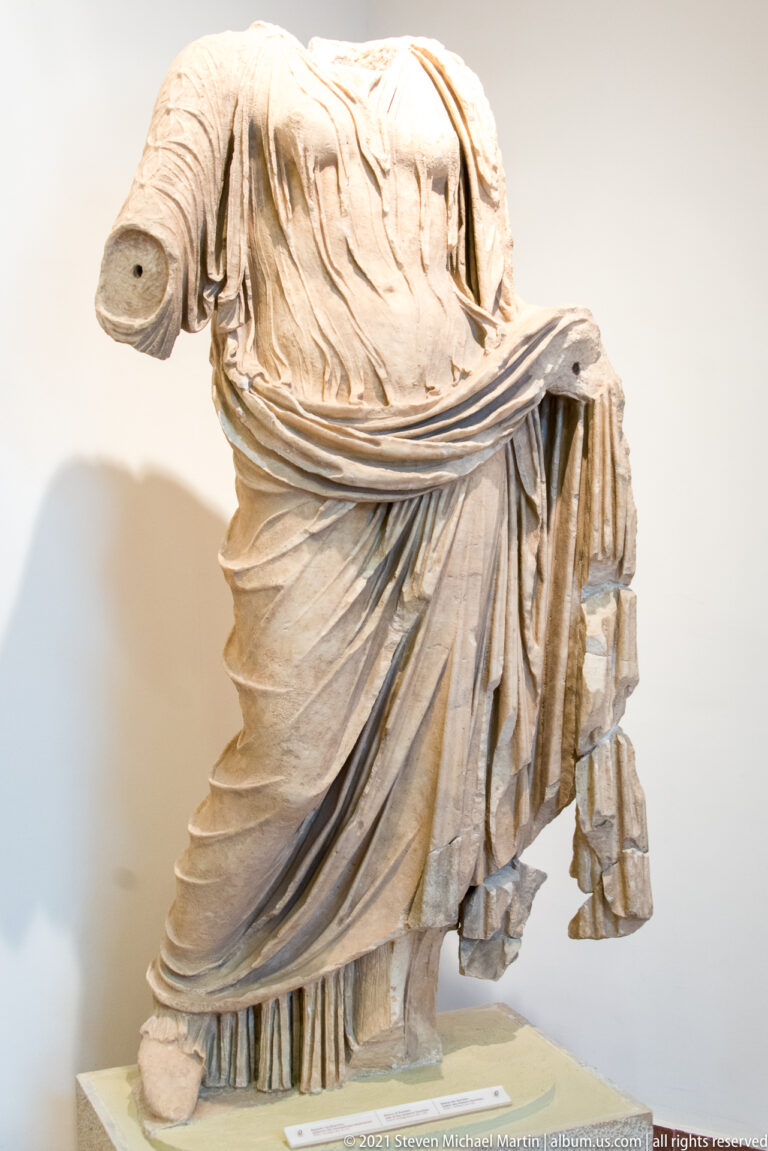 Fragmentary Nike of Paionios, circa 420 BC, with wind-blown marble drapery suggesting the goddess descending from above.