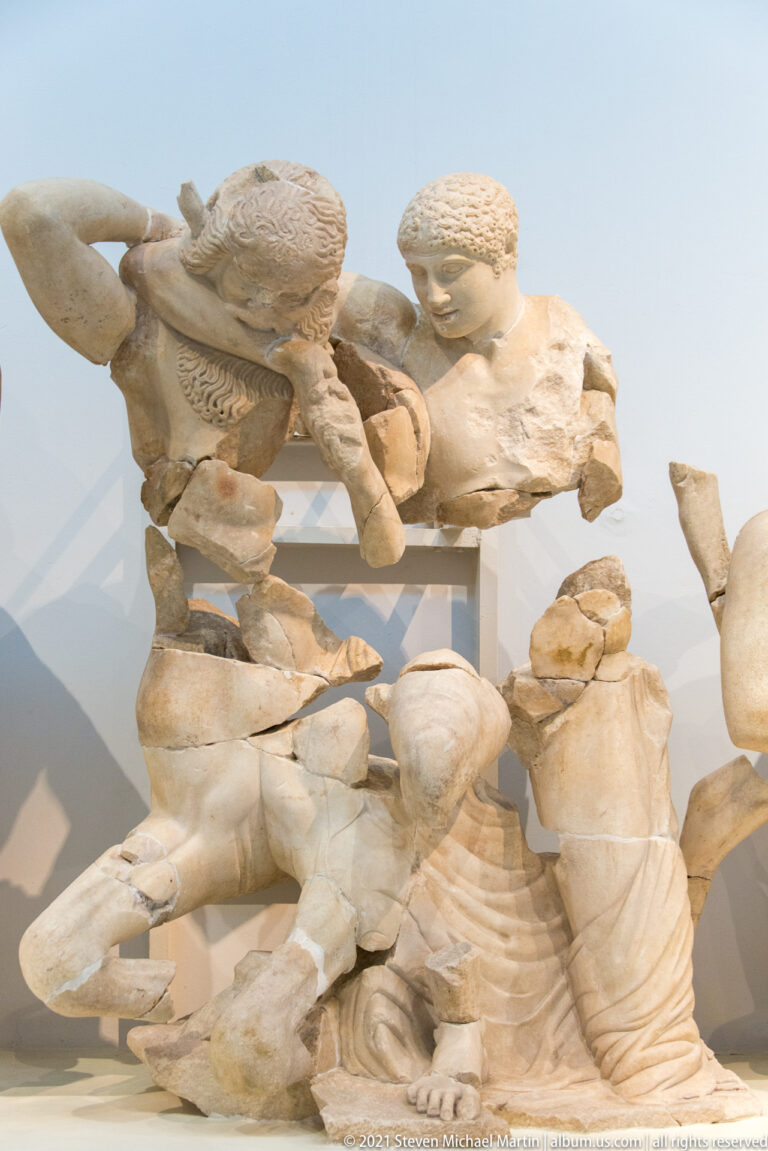 Fragmentary marble Lapiths and Centaurs struggling in the reconstructed west pediment of the Temple of Zeus.