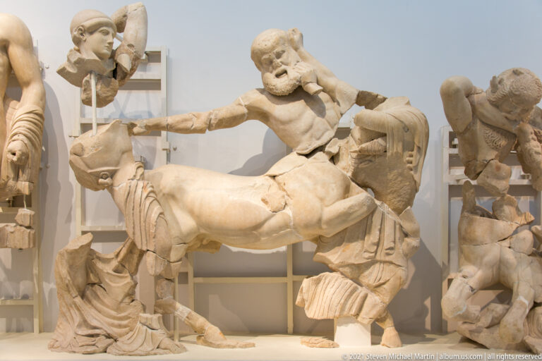 Marble Centaur lunging over a draped Lapith woman in the Temple of Zeus west pediment.