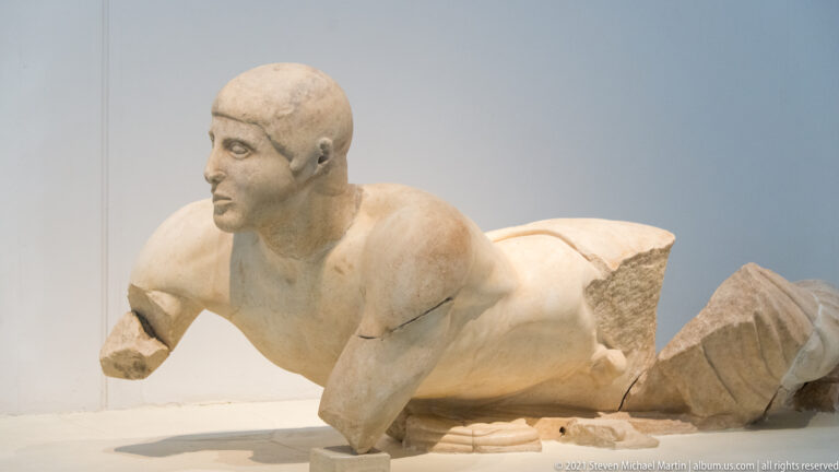 Kneeling fragmentary Herakles from a marble Temple of Zeus metope in the Twelve Labours cycle at Olympia.