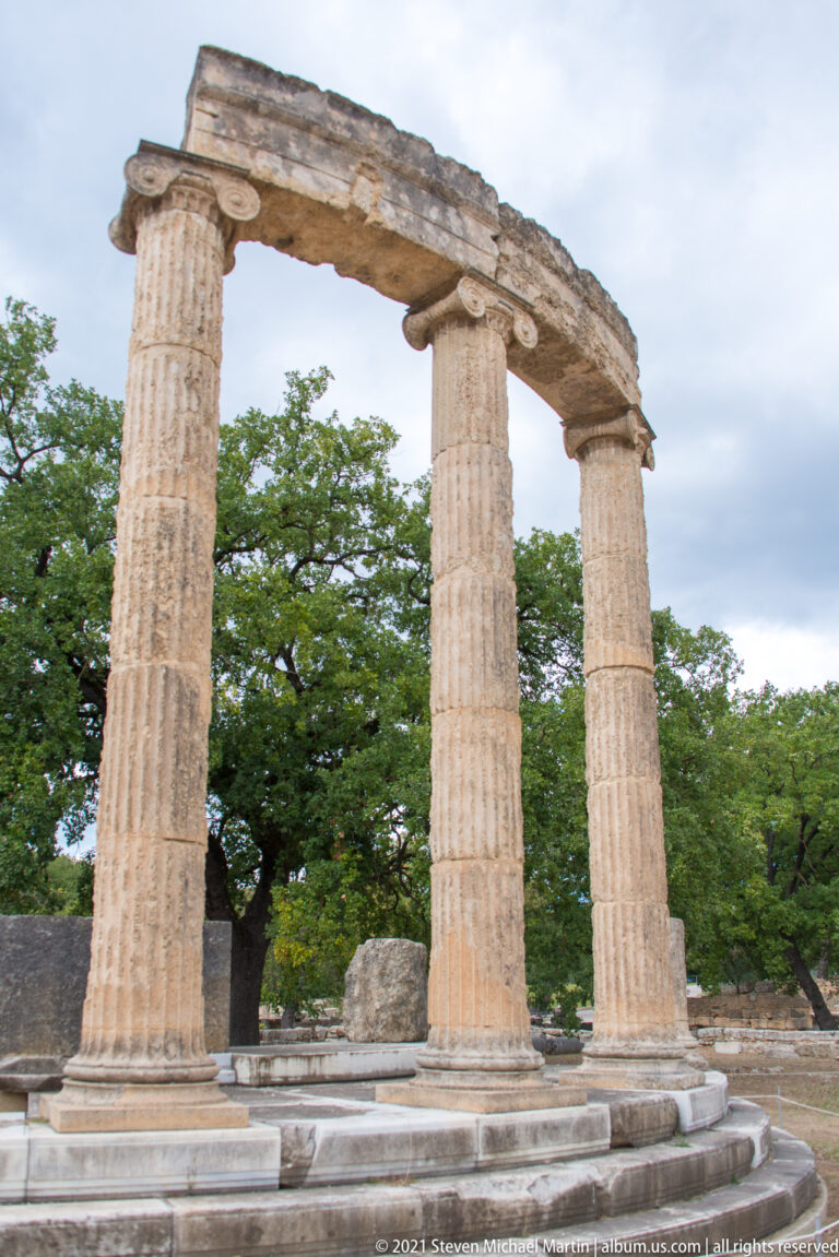Partial reconstruction of the Philippeion with three fluted Ionic columns, entablature, and circular stepped foundations.