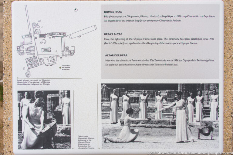 Interpretive panel at Ancient Olympia explaining Hera's Altar and the modern Olympic flame-lighting ceremony.