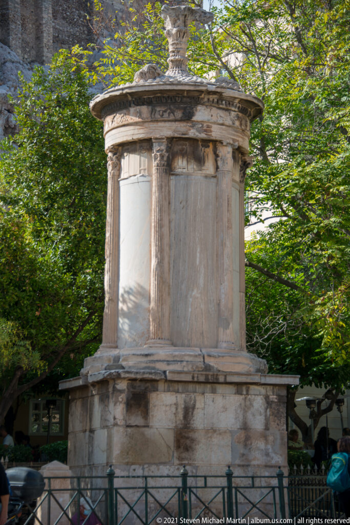 Choragic Monument of Lysicrates in Plaka, with circular marble core, engaged Corinthian columns, sculpted frieze, and crowning finial.