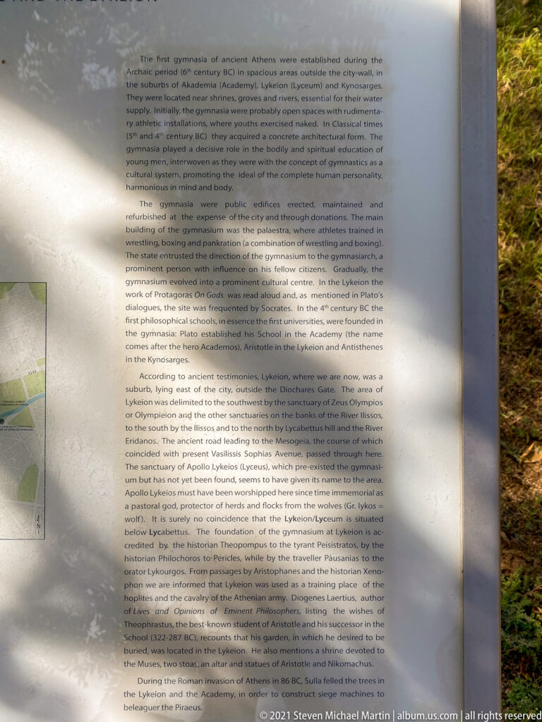 Outdoor interpretive panel with English text about ancient Athenian gymnasia, Plato's Academy, and Aristotle's Lykeion.