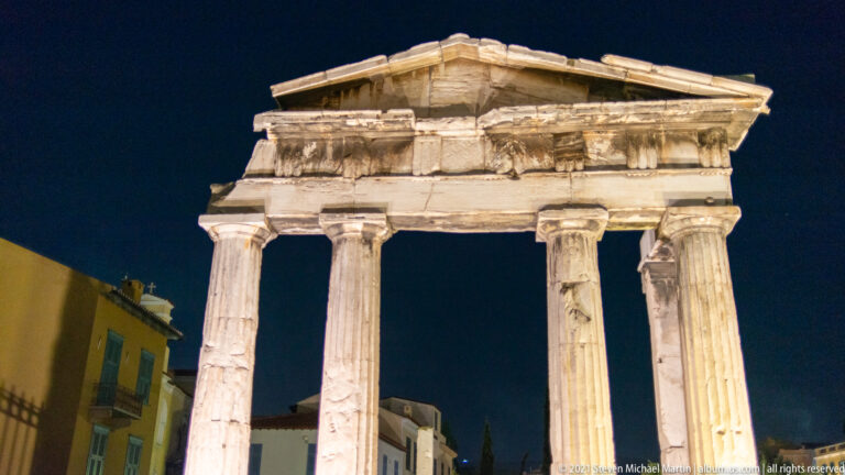 Frontal night view of the four Doric columns and triangular pediment of the Gate of Athena Archegetis.