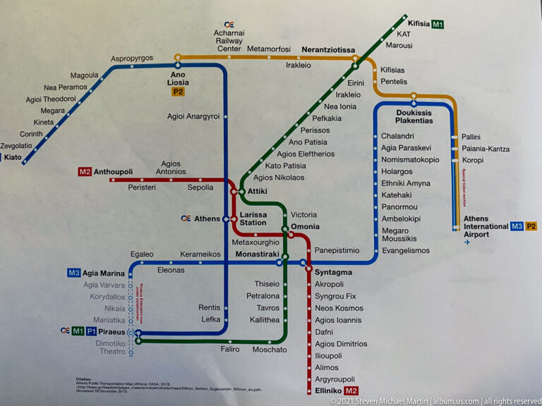 Color-coded Athens transit map showing metro lines, interchange stations, suburban rail branches, and the airport connection.