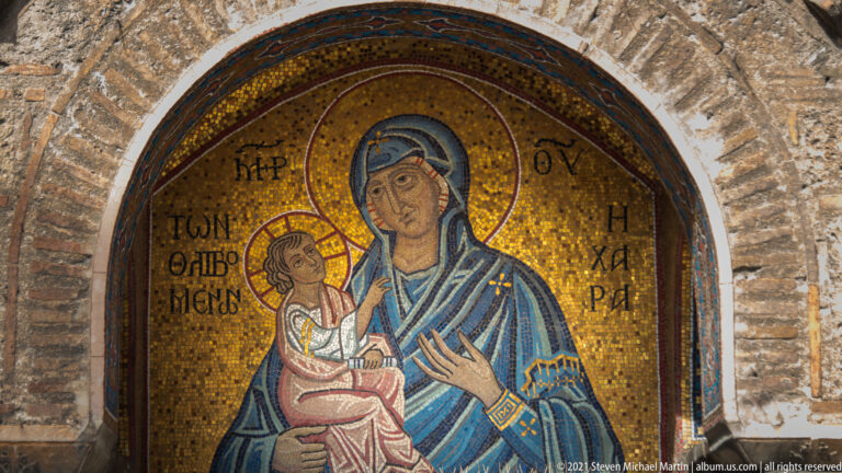 Gold-ground mosaic of the Virgin Mary holding Christ Child in an arched lunette at Panagia Kapnikarea.