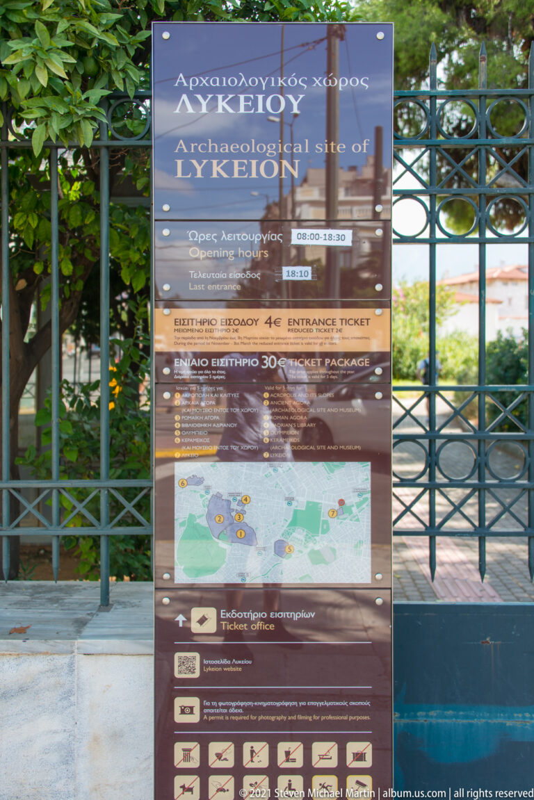 Bilingual entrance sign for the Archaeological Site of Lykeion with visitor information, ticket details, rules, and site map.