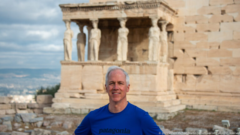 Male visitor before the Erechtheion, with the Caryatid copies of its south porch visible behind him.