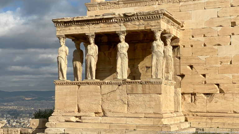 Sunlit south porch of the Erechtheion with six Caryatid copies supporting the entablature.