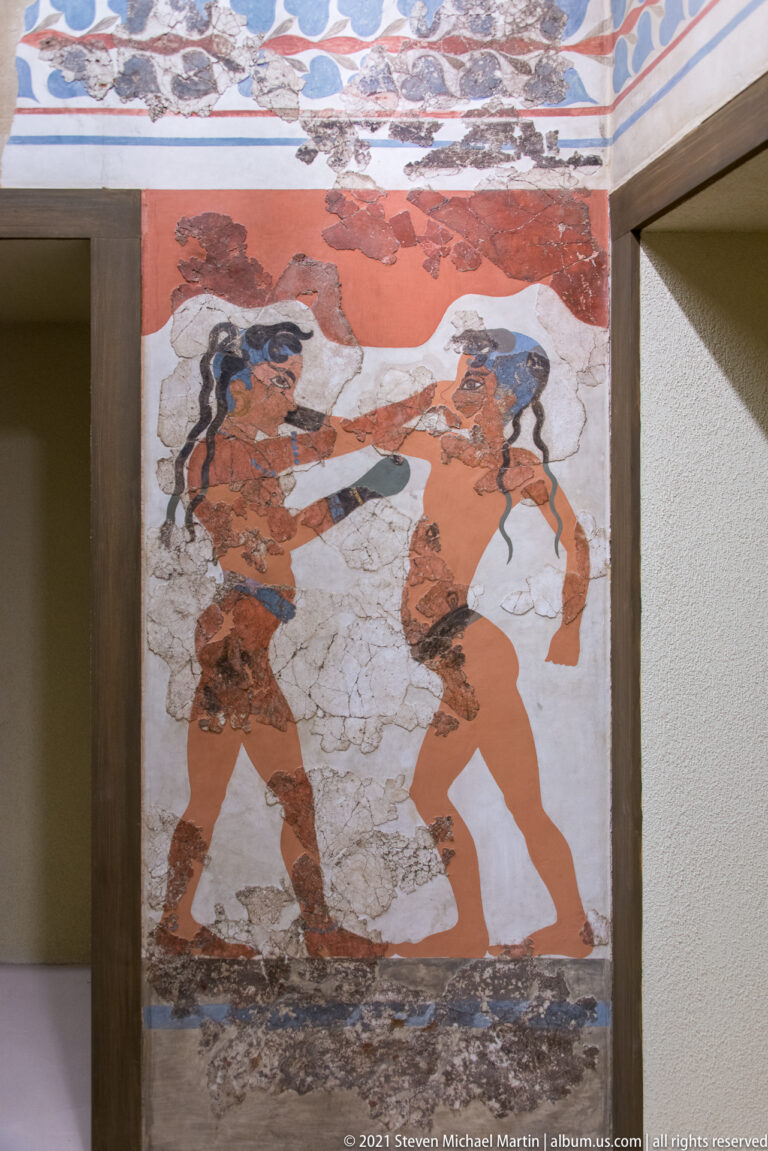 Boxing Children Fresco from Akrotiri on Thera, showing two young boxers facing each other with raised gloved hands.