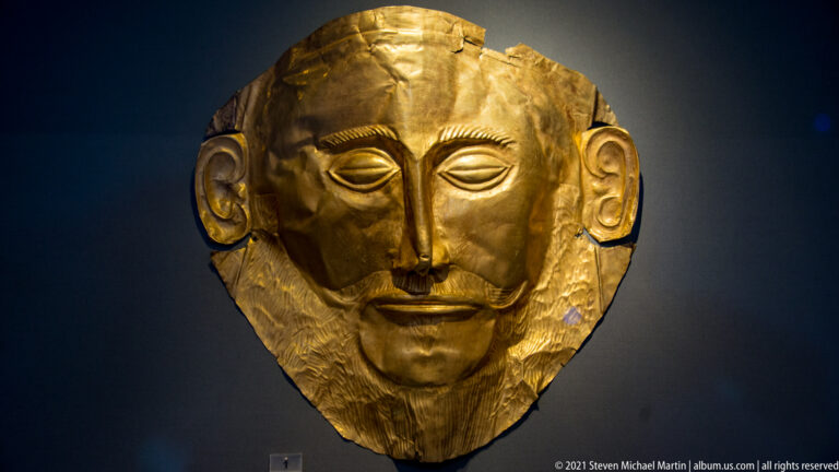 So-called Mask of Agamemnon, a hammered gold Mycenaean funerary mask with closed eyes, moustache, and engraved beard.