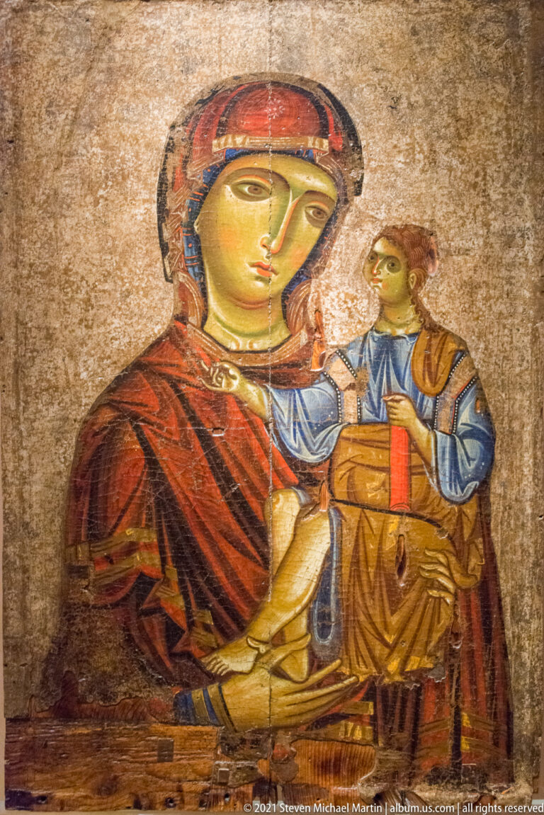 Icon of the seated Virgin holding the Christ Child, with red and blue garments against a worn gold ground.