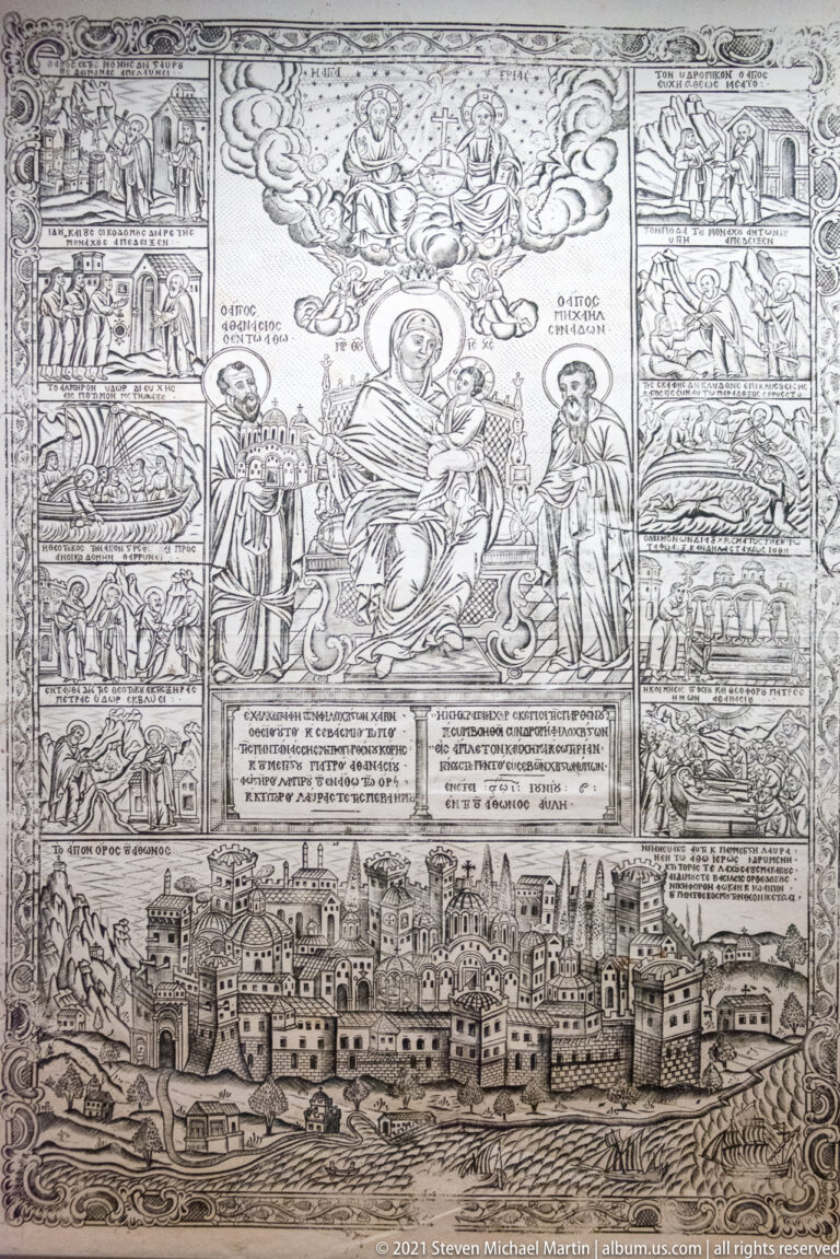 Monochrome religious engraving with a central sacred group, many surrounding narrative scenes, text blocks, and a fortified town panorama below.