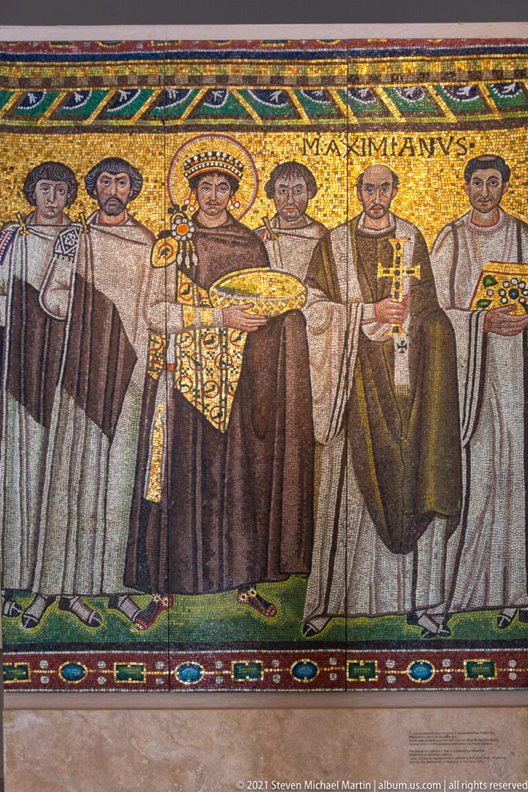 Gold-ground mosaic scene of Emperor Justinian standing frontally among clergy, officials, and attendants.